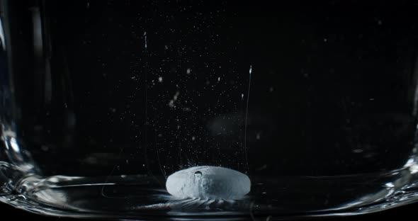 Timelapse of Blue Medicine Pill Capsule Dissolving in Water like a Decomposing Drug Capsule in Stoma