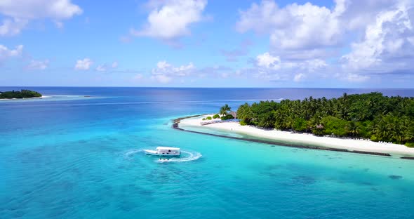 Natural fly over travel shot of a summer white paradise sand beach and aqua blue ocean background 