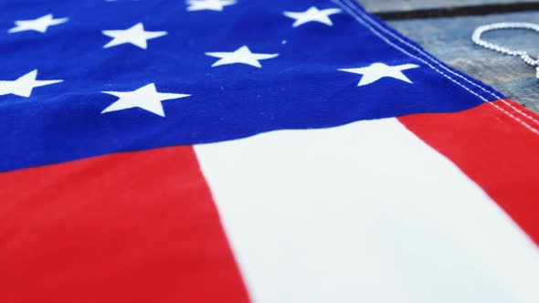 American flag and dog tag on a wooden table