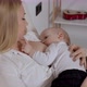 Young Blonde Woman Hugging and Feeding with Breast Her Baby Boy - VideoHive Item for Sale