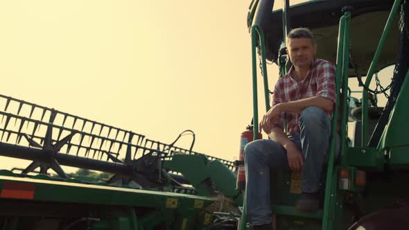 Harvester Driver Resting Field in Sunlight