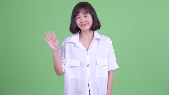 Happy Beautiful Asian Businesswoman Waving Hand