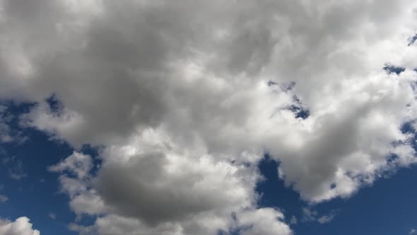 Time lapse of cumulus clouds moving in sky. Low angle