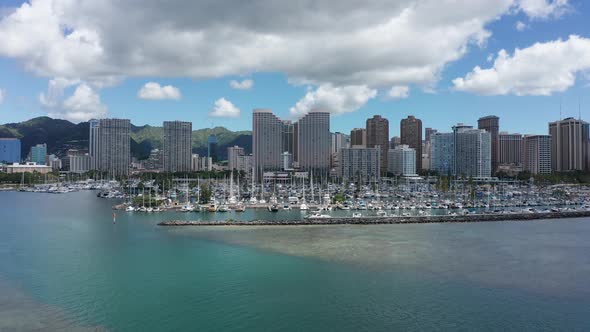 Rising aerial shot of a yacht marina in downtown Honolulu on the island of O'ahu, Hawaii. 4K