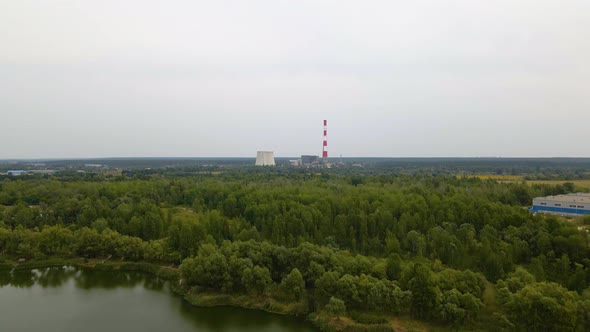 Aerial view over a river and forest, towards the TES 6 coal power plant, cloudy day, in Kiev, Ukrain