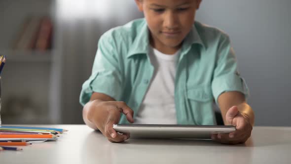 Male Kid Enthusiastically Playing on Tablet, Addiction to Gaming, Problem