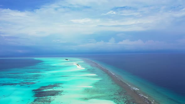 Aerial nature of perfect coast beach vacation by blue water and white sandy background of a dayout n