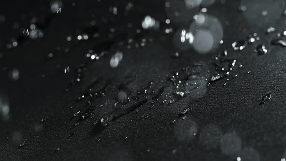 Super Slow Motion Shot of Water Droplets Splashing on Waterproof Cloth at 1000Fps