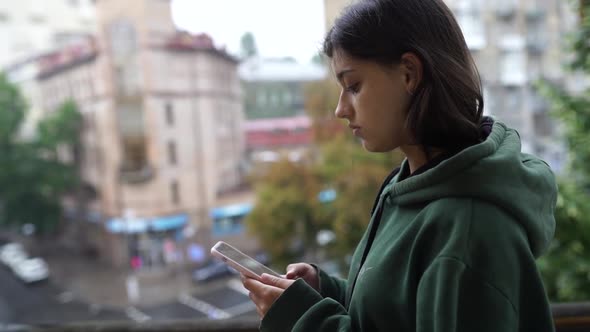 Upset Woman Holding Cellphone Disgusted with Message