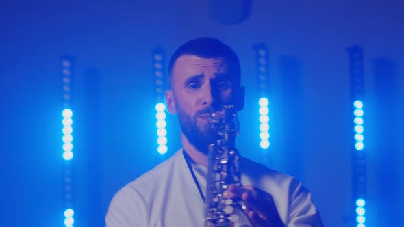 Live Performance of Saxophonist Man with Saxophone Dancing on Concert Musician Stage with Lights