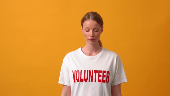 Concentrated woman volunteer opening eyes at the camera