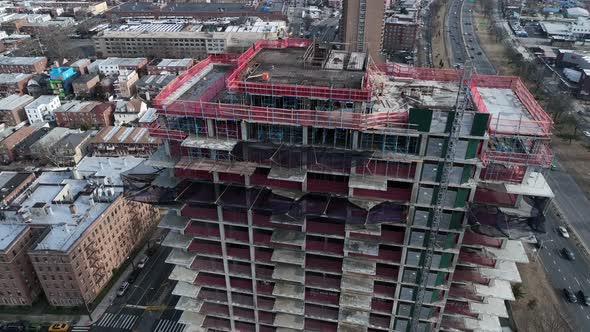 A high angle view above Shore Parkway and a new high-rise construction site in Brooklyn, NY. The dro