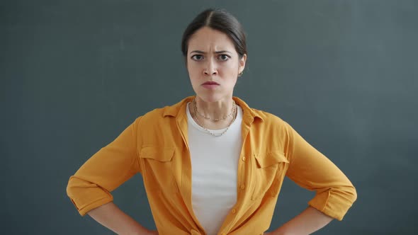 Angry Young Lady Getting Bad News Opening Mouth and Looking at Camera with Disagreement