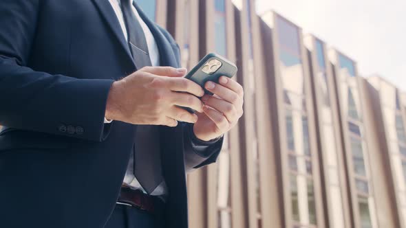 Confident businessman in front of modern office building. Financial investor outdoor.