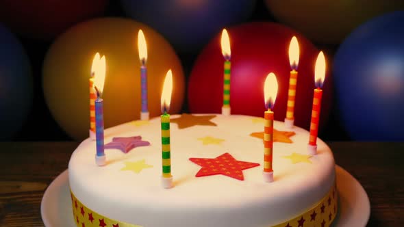 Candles On Birthday Cake With Colorful Balloons