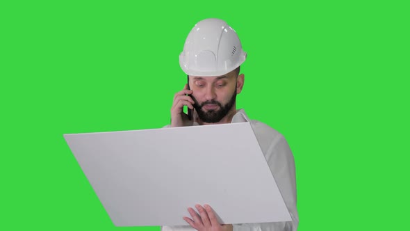 Engineer in Formalwear and Hardhat Talking To Client or Contractor on Mobile Phone and Looking at