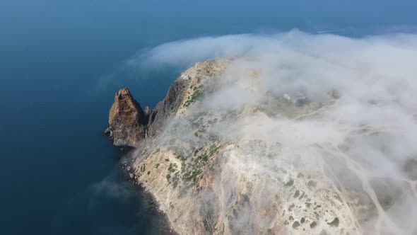 Aerial View From Above on Calm Azure Sea and Volcanic Rocky Shores