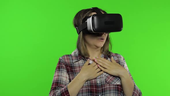 Girl Using VR App Helmet To Play Simulation Scary Game. Woman Watching Virtual Reality 3D Video