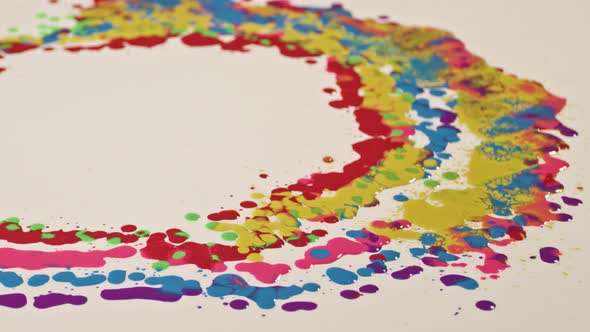 Various colors are dripping on a white background.