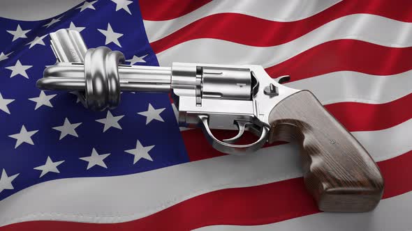 Revolver with a knot on the barrel. Handgun on waving American national flag 4K