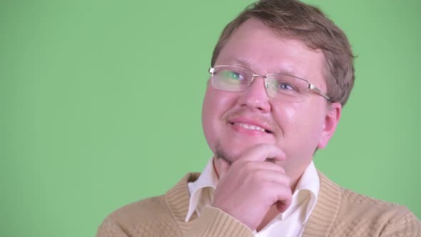 Face of Happy Overweight Bearded Man Thinking and Looking Up