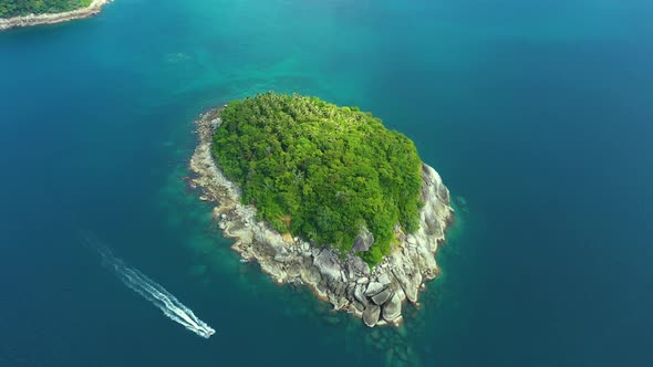 Nice rocks forested island, aerial panorama of Ko Pu against mountainous Phuket landscape on backgro