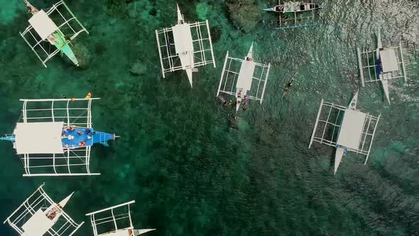 Aerial view of Pescador Island with traditional filipino boats, Philippines.