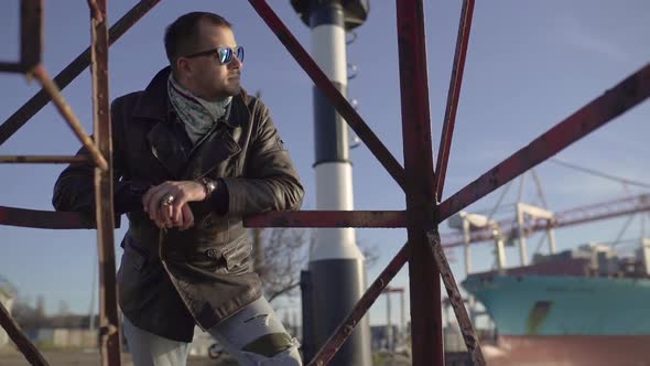 Portrait of Handsome Man in the Harbor at Cold Sunny Day