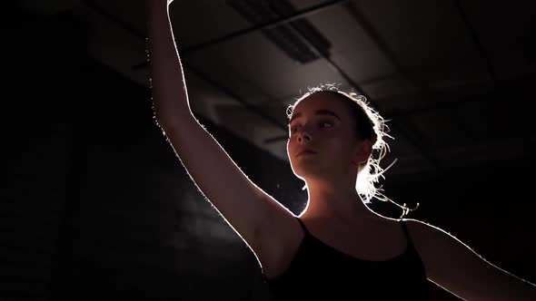 Beautiful Young Ballerina on Pointe Shoes at Darkness