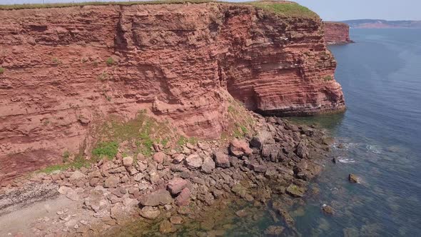 4K, Aerial RISING view of Jurassic Coast red cliffs, UK