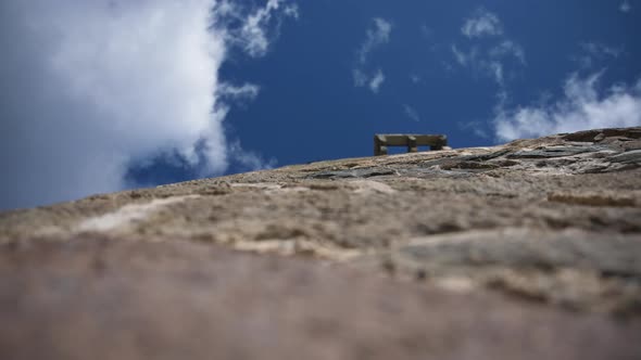 Ancient stone wall and moving clouds