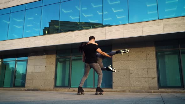 Romantic Couple on Roller Skaters Performing Extreme Choreography