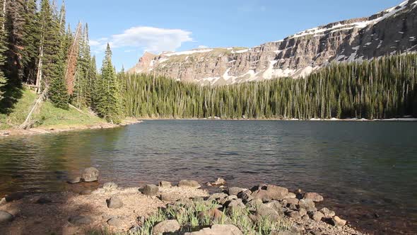 Remote Deep Lake located below the Chinese Wall cliffs in the Flat Tops Wilderness Area, Colorado, U