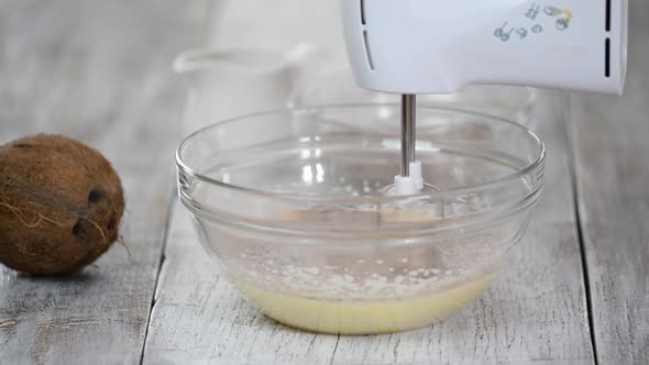 Chef Prepares Dough for Baking. Adding Flour in Glass Bowl and Stirring with Mixer.