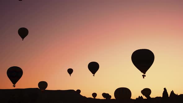 Silhouettes of Hot Air Balloons Over Sunset Background.