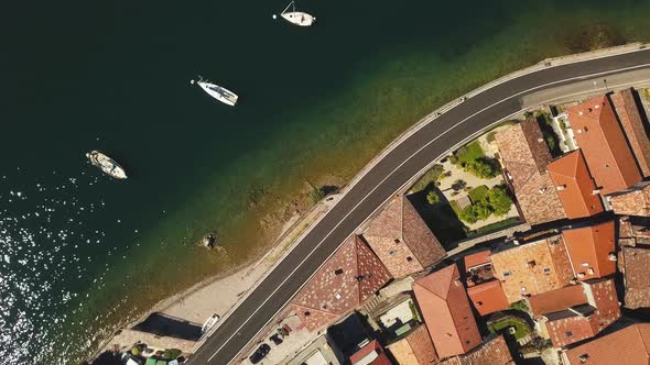 From Drone Vertically On The Italian Lake With Boats And Coast Road1