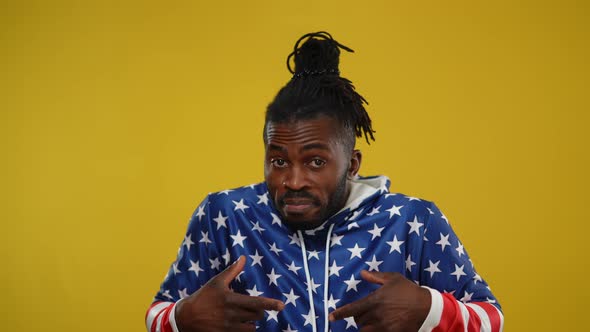 Portrait of African American Handsome Man Denying Gesturing at Yellow Background