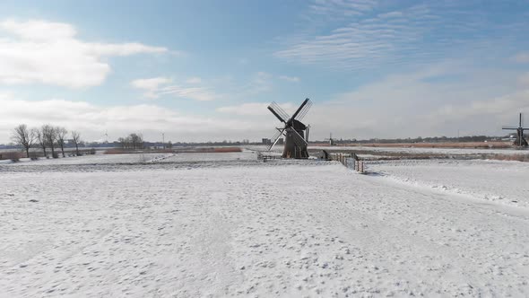 Winter snow covering Dutch windmills, traditional winter aerial landscape