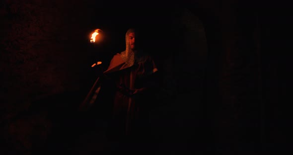 Viking Holds a Flame Torch in the Night