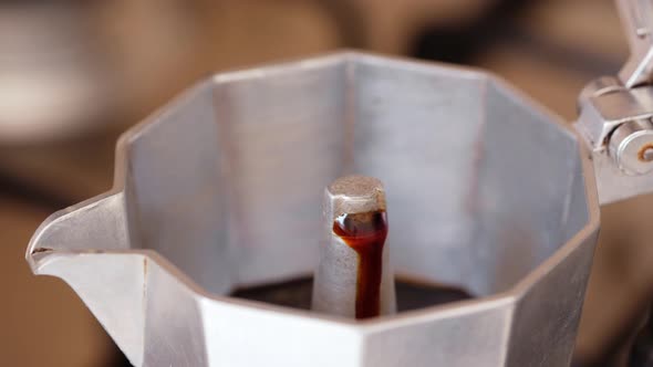 Hot Espresso Coffee Spilling Out of an Italian Traditional Moka Pot.