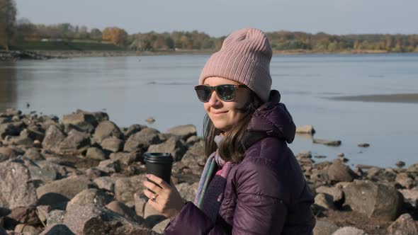 Young Woman Enjoying Sunny Autumn Day at Beach