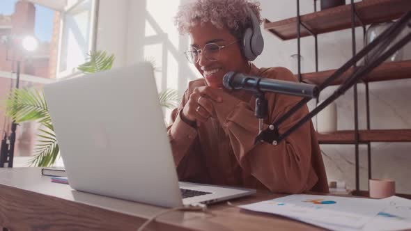 African Woman Has Online Fashion Stream Wears Headphones and Microphone