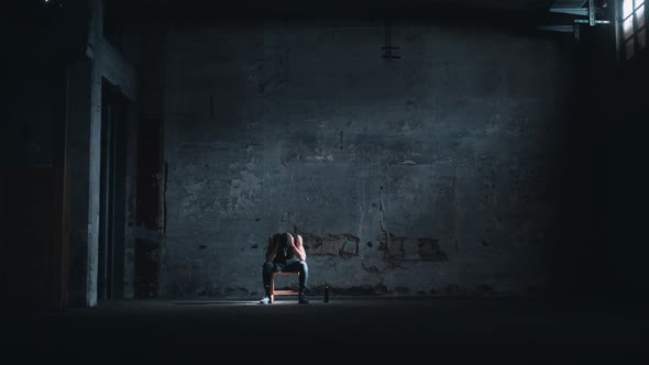 Man alone in a dark room