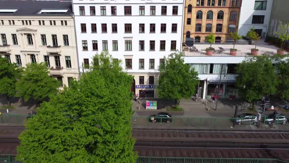 Beautiful apartment building on the elevated railroad line Eberswalder. Aerial view flight tilt down