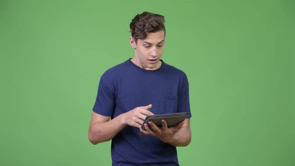 Young Handsome Teenage Boy Using Digital Tablet