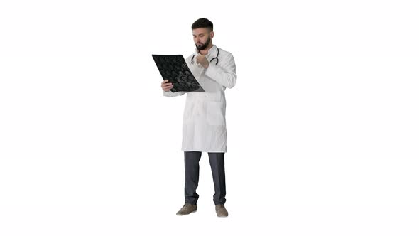 Arab Doctor Reading and Reviewing a MRI Brain Scan on White Background
