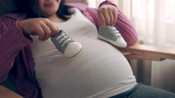 Happy Pregnant Woman and Expecting Baby at Home