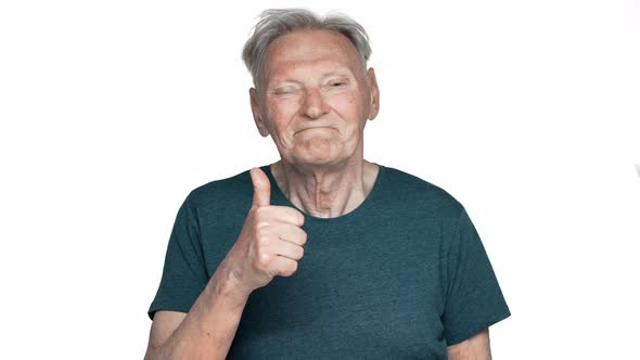 Portrait of Healthy Pensioner Man 80s Having Gray Hair in Basic Tshirt Grinning and Showing Thumb Up