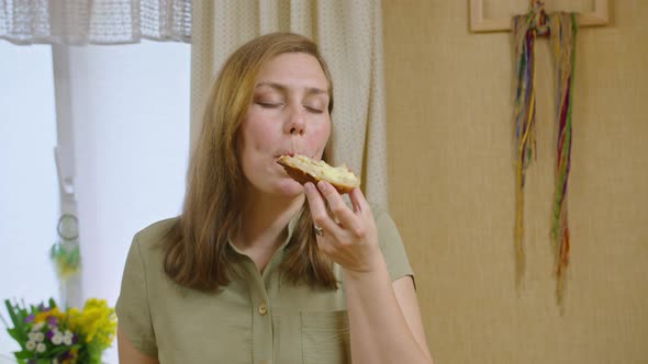 Commercial Footage a Young Girl Cuts Bread with a Knife Spreads a Sandwich with Butter and Pours