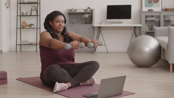 African-American Sporty Woman Having Workout by Internet